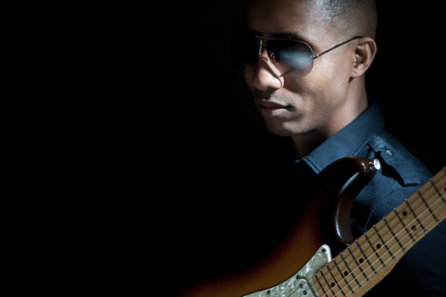 Musician resting guitar on shoulder
